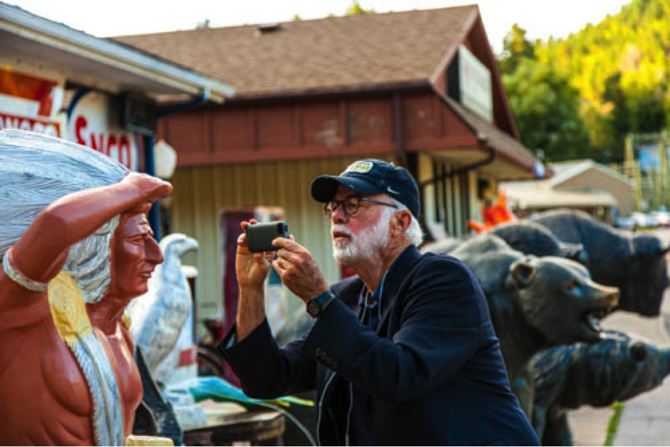 David Hume Kennerly takes a photo of a statue in Deadwood. 